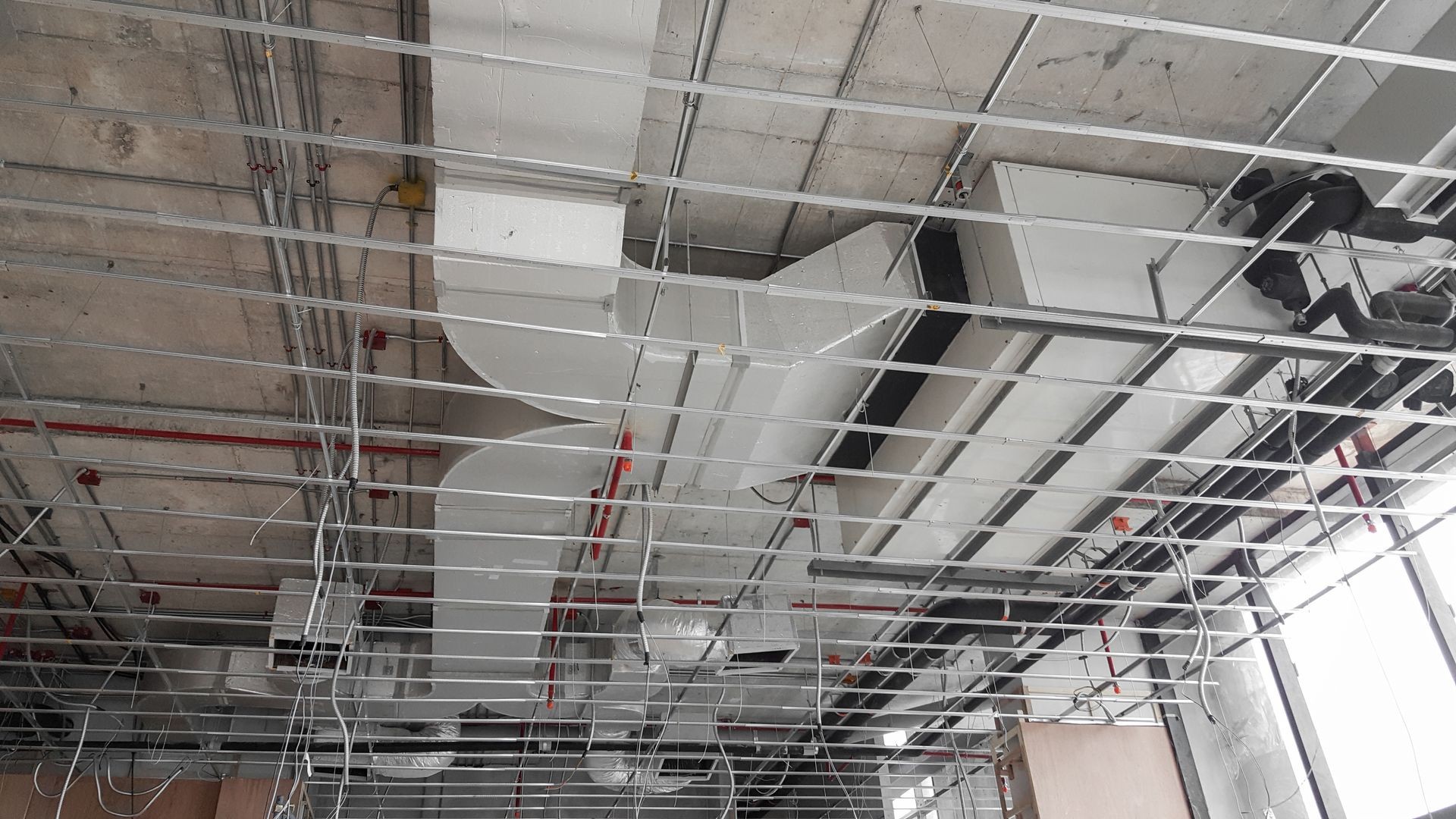 Air condition and hvac system installation under bareskin ceiling before interior finishing.