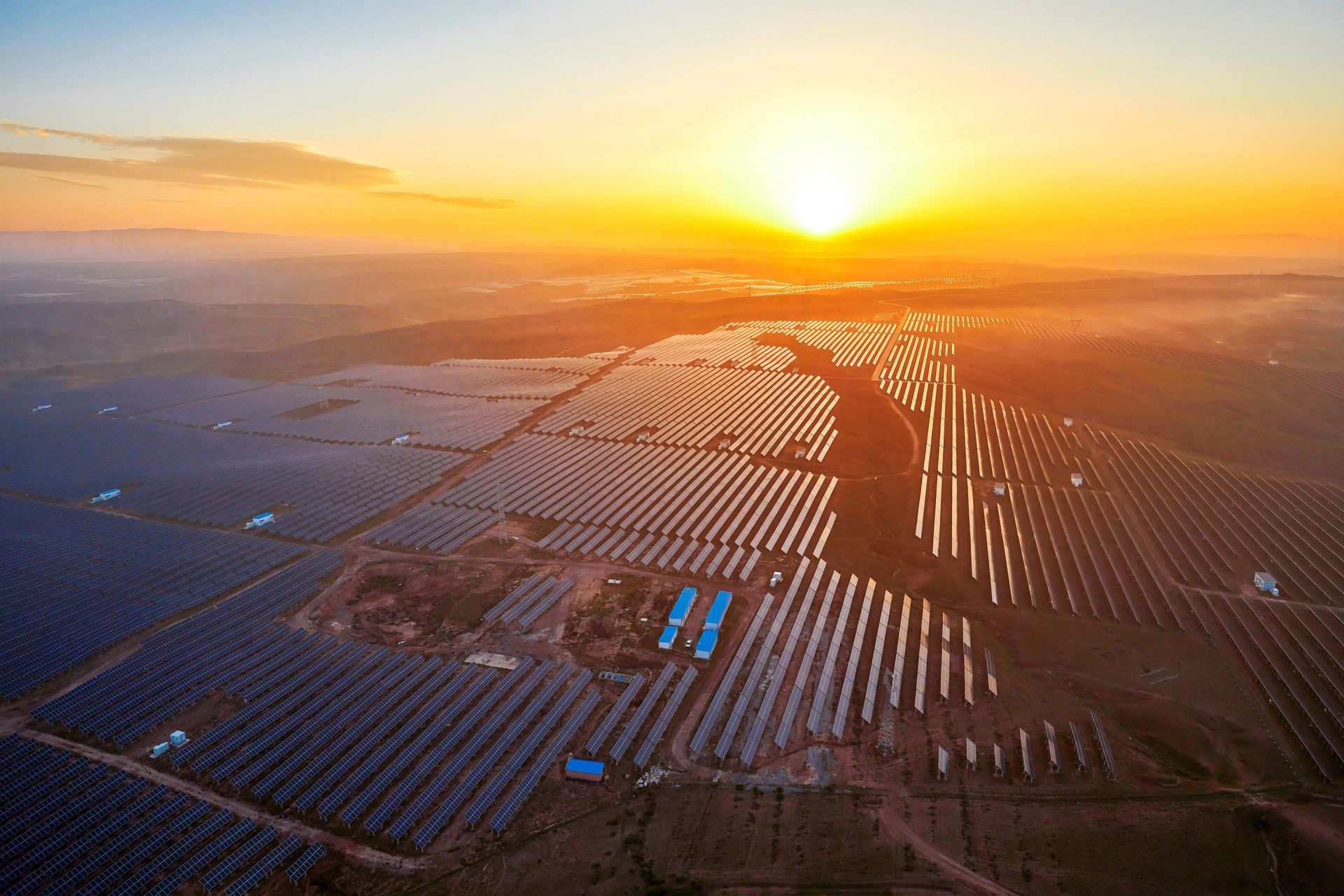Aerial photo of new energy solar photovoltaic panels outdoors at sunrise